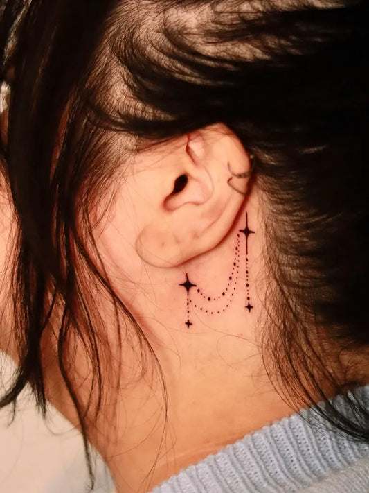 Small Fine Line Star Chain Tattoo on Women Behind the Ear by @butaytattoo