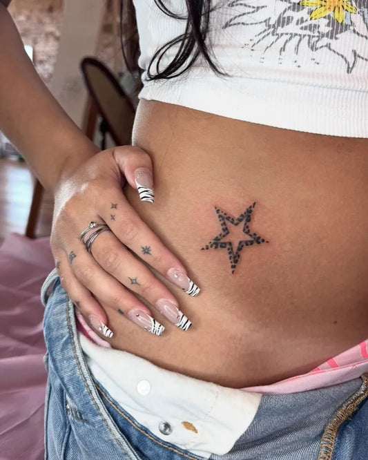 Small Fine Line Star Tattoo on Women Abdomen by @inkbygal