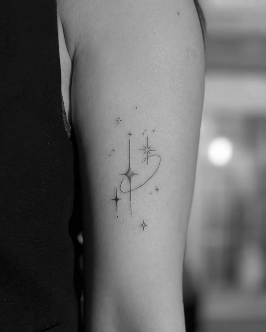 Small Fine Line Star and Orbit Tattoo on Women Arm by @tattoo_sss_sandra