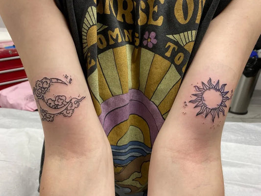 Small Fine Line Sun and Moon Tattoo on Women Bicep by @brigitte_tattoos