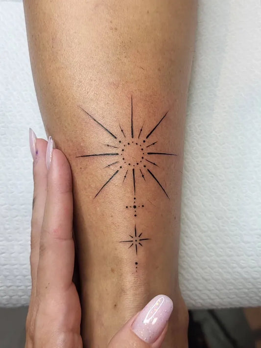 Small Fine Line Sun and Stars on Women Ankle Tattoo by @naked___tattoo