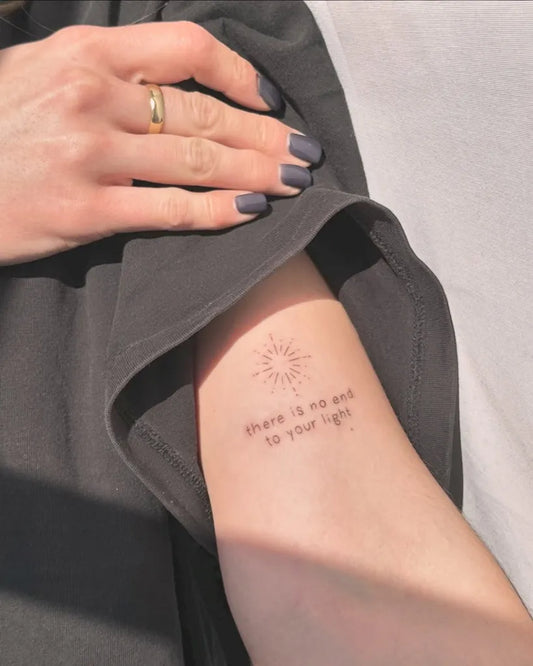 Small Fine Line Sun and Text on Women Arm Tattoo by @azurateliertattoo