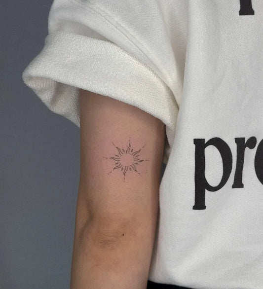 Small Fine Line Sun on Women Arm Tattoo by @coconotattoo