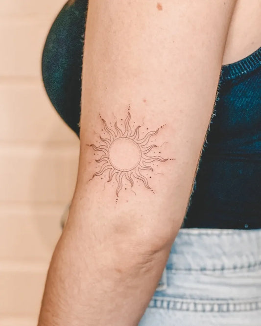 Small Fine Line Sun on Women Arm Tattoo by @the.tinyvegan