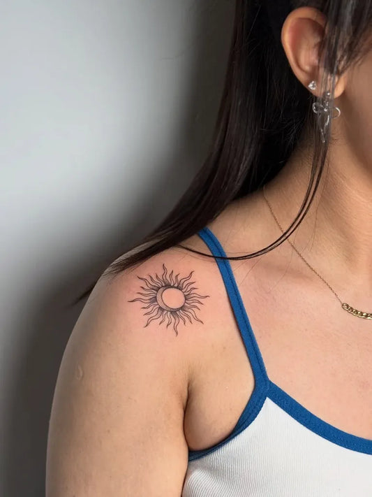 Small Fine Line Sun on Women Shoulder Tattoo by @mobitattoo