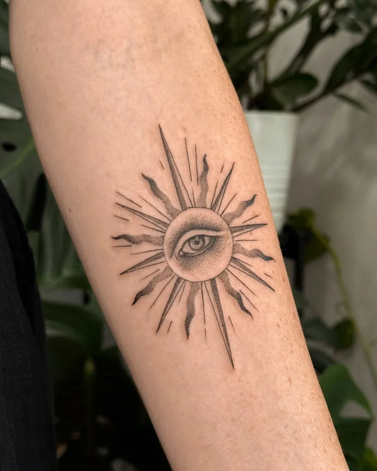 Small Fine Line Sun with Eye on Women Arm Tattoo by @thatbloomkid