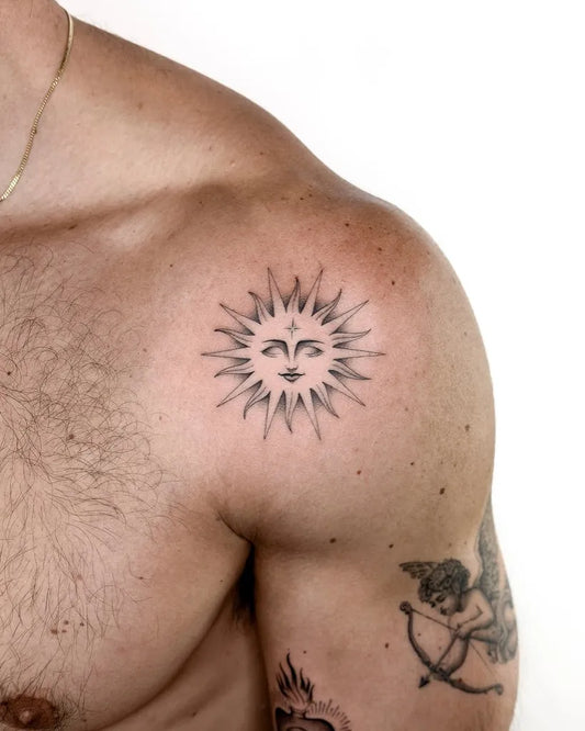 Small Fine Line Sun with Face on Men Shoulder Tattoo by @alexlloydtattoo