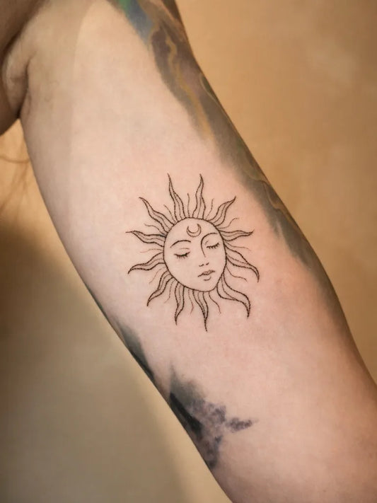 Small Fine Line Sun with Moon Face on Women Arm Tattoo by @bless_dot