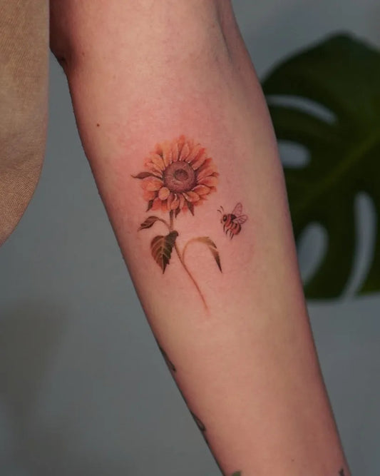 Small Fine Line Sunflower and Bee on Women Arm Tattoo by @o.dovmat.tattoo