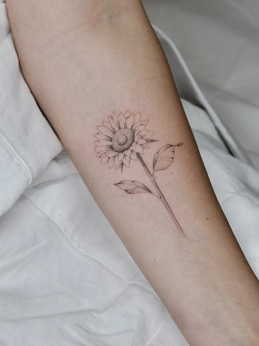 Small Fine Line Sunflower on Women Arm Tattoo by @alice.artattoo