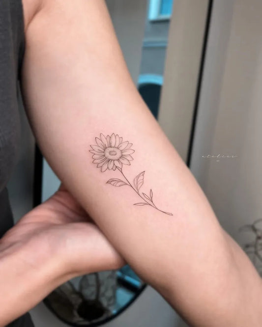 Small Fine Line Sunflower on Women Arm Tattoo by @atelier____m_