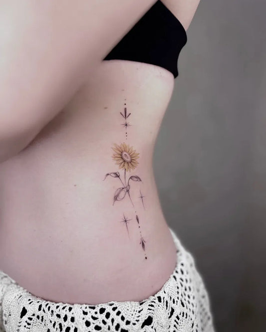 Small Fine Line Sunflower with Dots and Lines on Women Side Tattoo by @dudutattooist