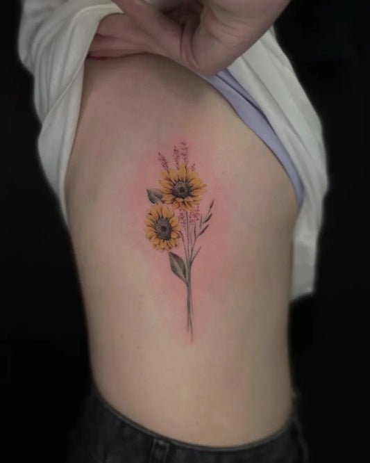 Small Fine Line Sunflowers and Wildflowers Tattoo on Women Rib by @jayprick_tattoos