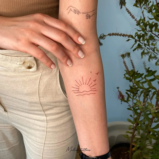 Small Fine Line Sunset Hand Waves on Women Arm Tattoo by @meliketattoos