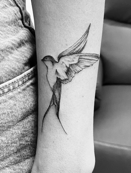 Small Fine Line Swallow Bird Tattoo on Women Arm by @harel.asaf.tattoo