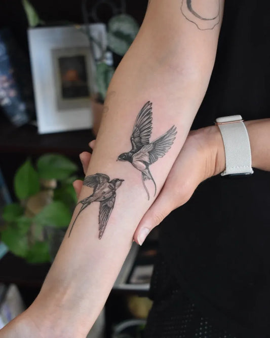 Small Fine Line Swallow Tattoo on Women Arm by @rathbone.tattoo