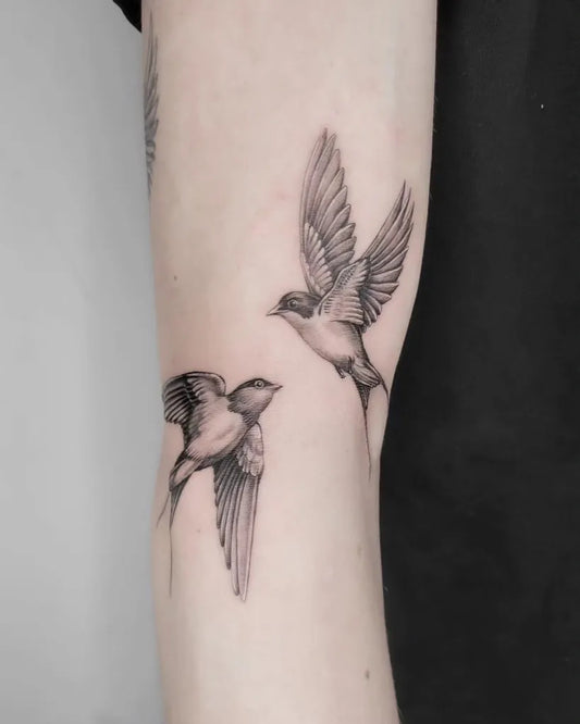 Small Fine Line Swallow Tattoo on Women Arm by @thirdgardenstudio