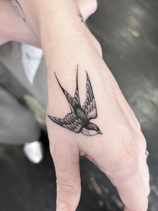 Small Fine Line Swallow Tattoo on Women Wrist by @lukesmithtattoo