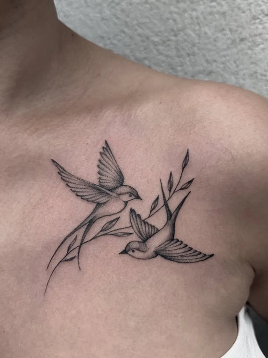 Small Fine Line Swallow and Sprigs Tattoo on Women Shoulder by @sparrowtattoostudio