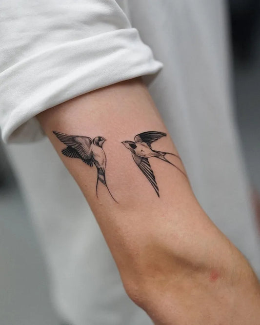Small Fine Line Swallows Tattoo on Women Arm by @andreas.givskov