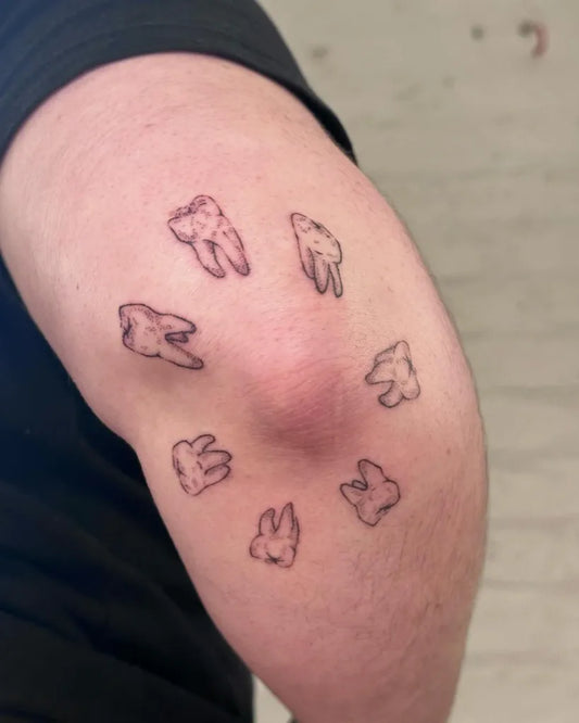 Small Fine Line Teeth Tattoo on Men Elbow by @savage.sticks