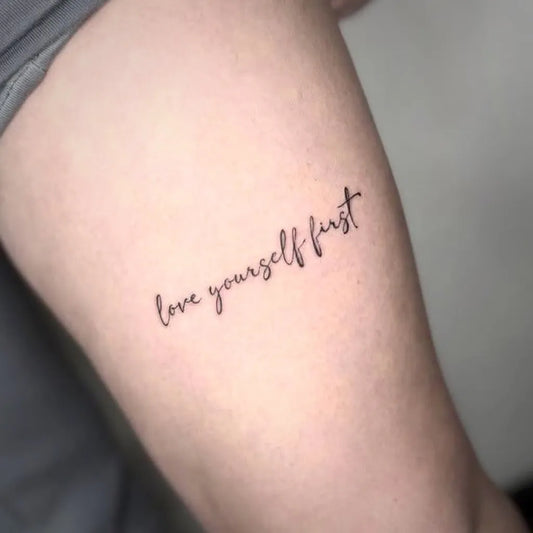 Small Fine Line Text Quote Tattoo on Women Thigh by @undergroundtattoos_enfield
