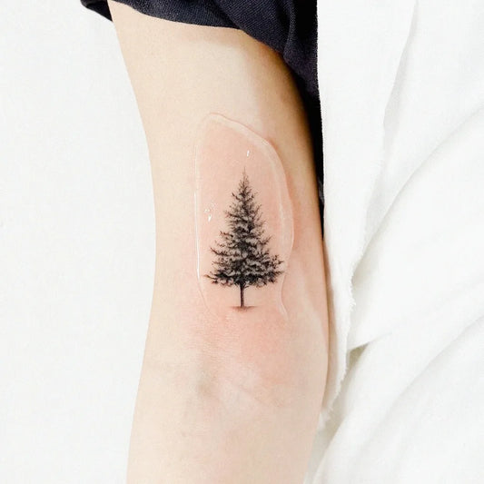 Small Fine Line Tree Tattoo on Women Upper Arm by @eontattoo