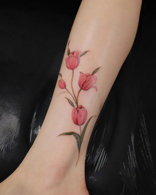 Small Fine Line Tulip Stem Tattoo on Women Leg by @its.freegee