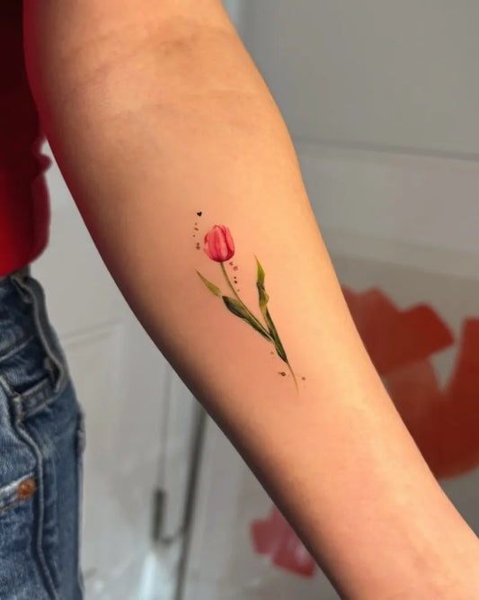 Small Fine Line Tulip Tattoo on Women Arm by @hurshy_tattoo