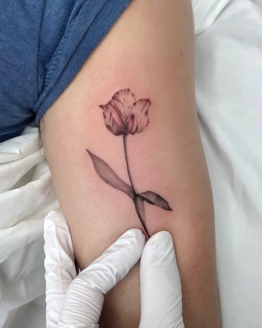 Small Fine Line Tulip Tattoo on Women Arm by @mooji_tt