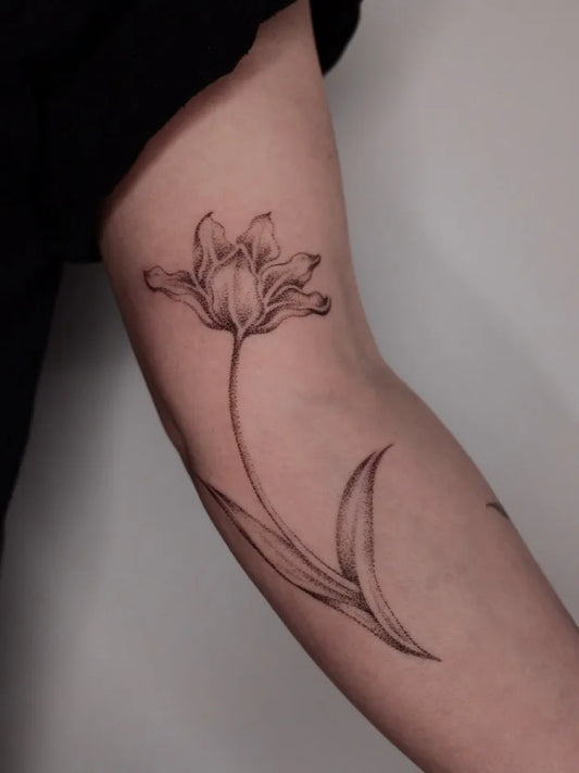 Small Fine Line Tulip Tattoo on Women Arm by @nicnpoke