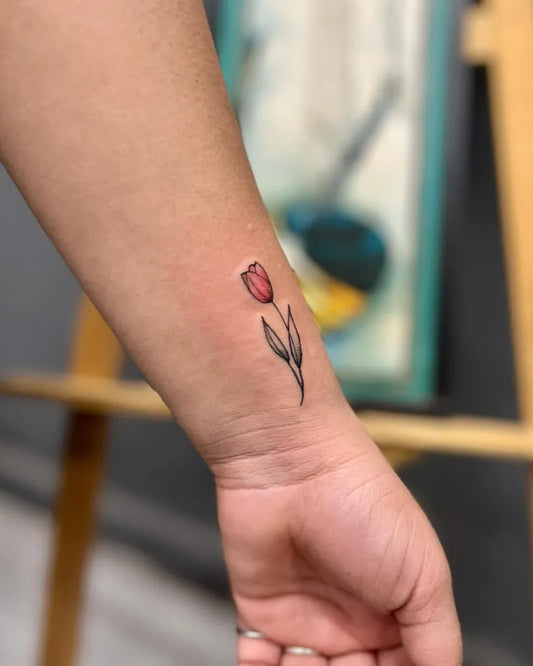 Small Fine Line Tulip Tattoo on Women Wrist by @psytric_acid_