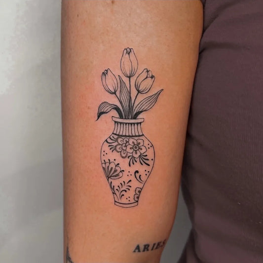 Small Fine Line Tulip in Vase Tattoo on Women Arm by @gumi.tattoos