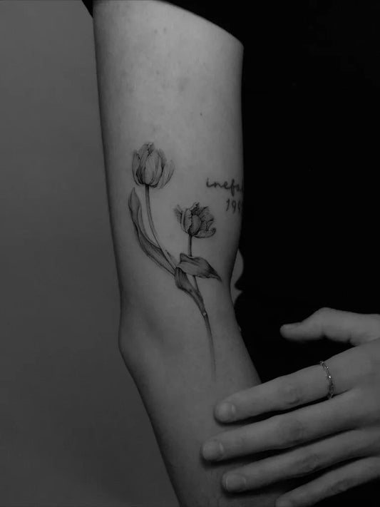 Small Fine Line Tulips Tattoo on Women Arm by @yo_soy_vago