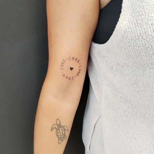 Small Fine Line Turtle and Heart with Dates Tattoo on Women Arm by @south_sirena