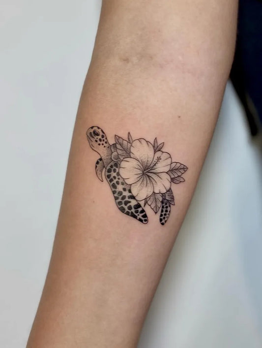 Small Fine Line Turtle and Hibiscus Tattoo on Women Forearm by @yantinotattoo_ubud