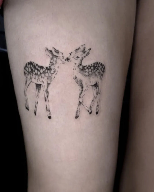 Small Fine Line Two Kissing Deer Tattoo on Women Thigh by @fridaatattoo