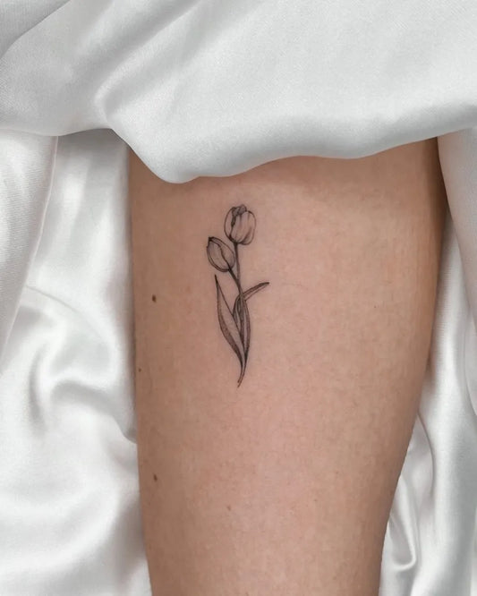 Small Fine Line Two Tulips Tattoo on Women Ankle by @monicabartiromo_tattoo
