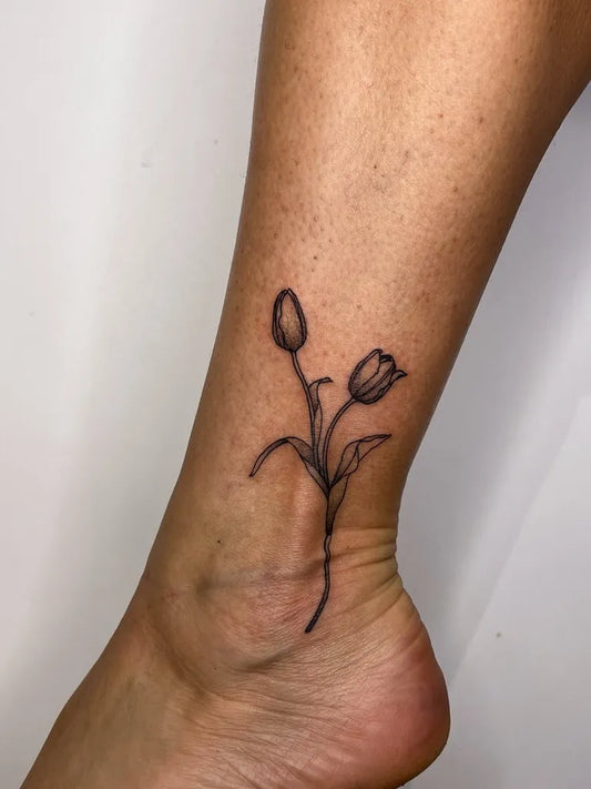Small Fine Line Two Tulips Tattoo on Women Ankle by @sienna_ttt