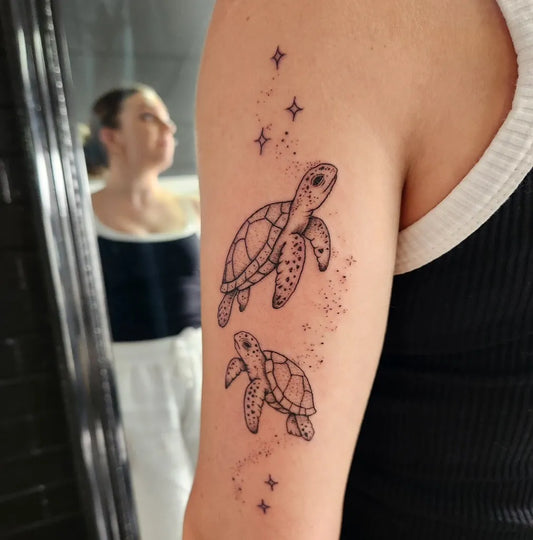 Small Fine Line Two Turtles with Stars Tattoo on Women Shoulder by @ginachanelartist