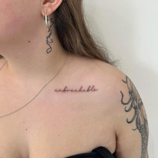 Small Fine Line Unbreakable Word Tattoo on Women Collarbone by @inkedby.chlo