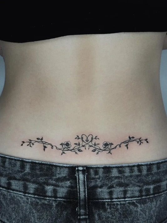 Small Fine Line Vine Flowers Tattoo on Women Lower Back by @swq457