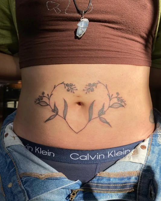 Small Fine Line Vine Heart Tattoo on Women Stomach by @minatattoos