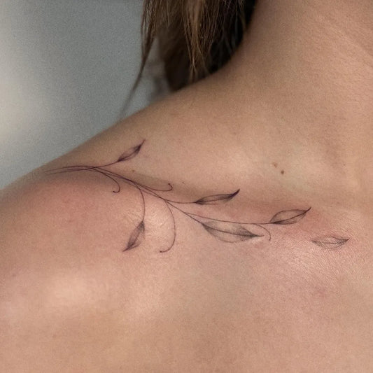 Small Fine Line Vine Tattoo on Women Collarbone by @dunkelbunt.tattoo