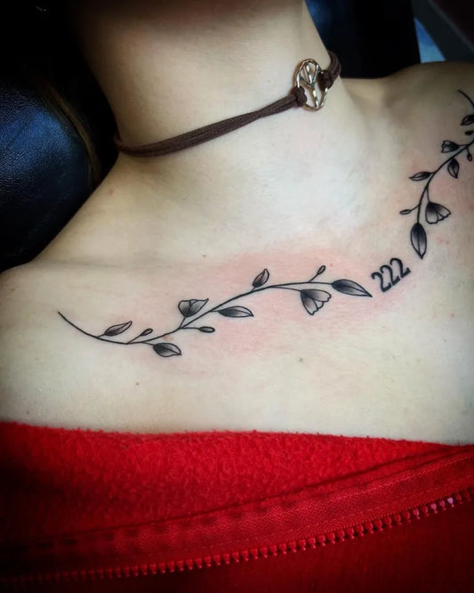 Small Fine Line Vine with Leaves and 22 Tattoo on Women Collarbone by @pinkflamingotattooshop