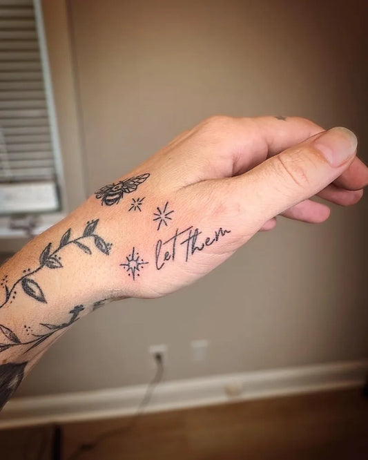 Small Fine Line Vines Let Them on Women Hand Tattoo by @glowing.withink