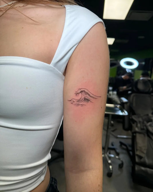 Small Fine Line Wave Tattoo on Women Arm by @cientattoo