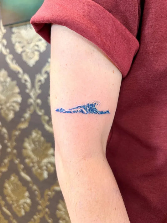 Small Fine Line Wave Tattoo on Women Arm by @okidtattoo