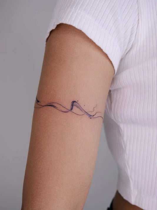 Small Fine Line Wave Tattoo on Women Arm by @secondb_tattoo