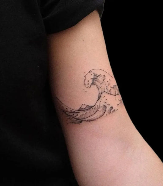 Small Fine Line Wave Tattoo on Women Arm by @sntattooinksinn